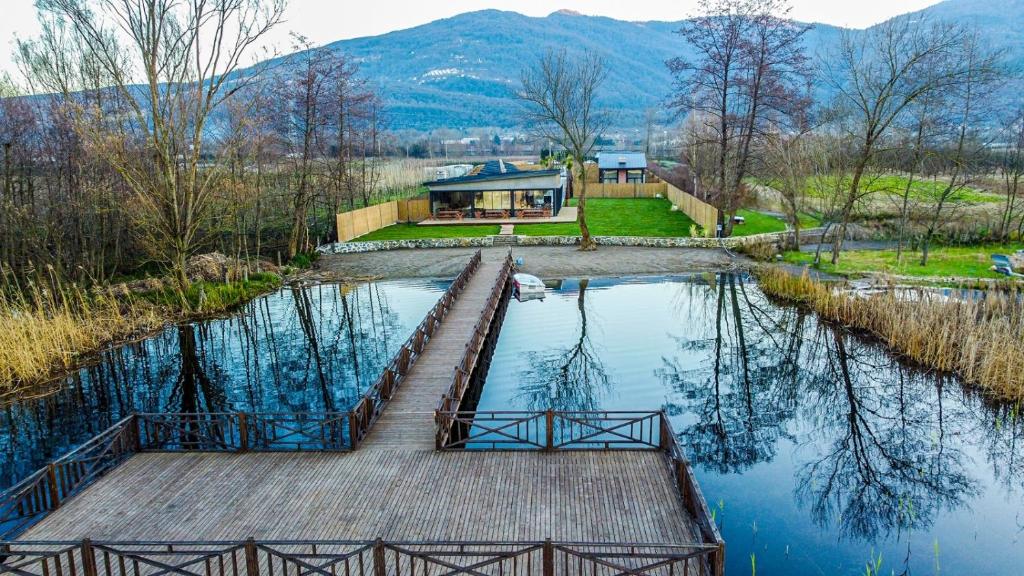 a house on a dock in the middle of a lake at Vital Göl Sapanca Isıtmalı Havuzlu Bungalov & Villa in Sapanca