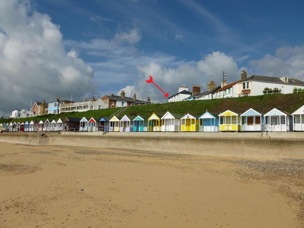 a row of houses on the beach with a kite at 10a East Cliff in Southwold