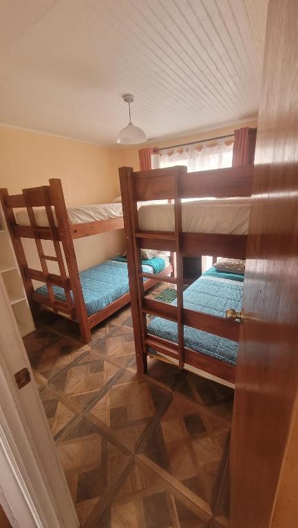 a room with two bunk beds in a house at Casas Rocamar in Totoralillo