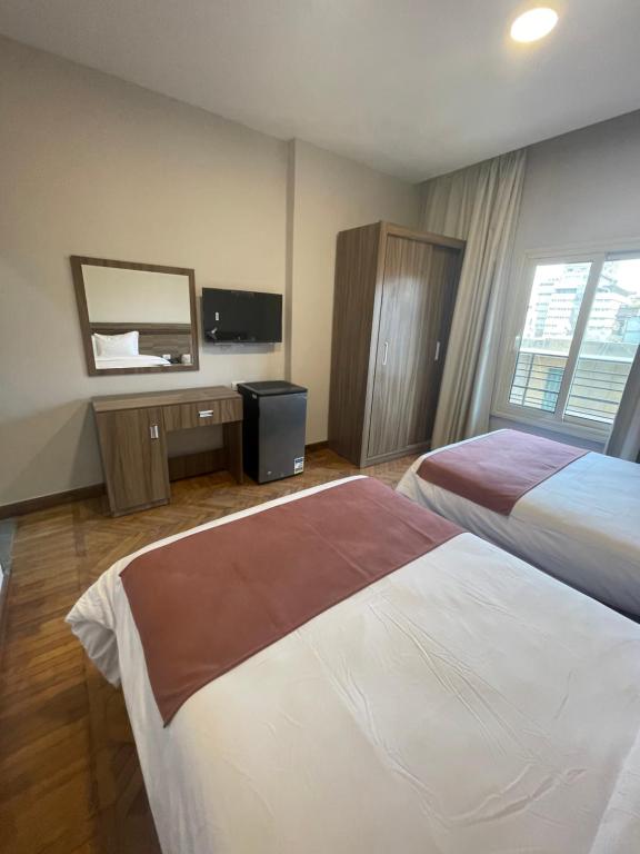 Postel nebo postele na pokoji v ubytování New Lotus Hotel
