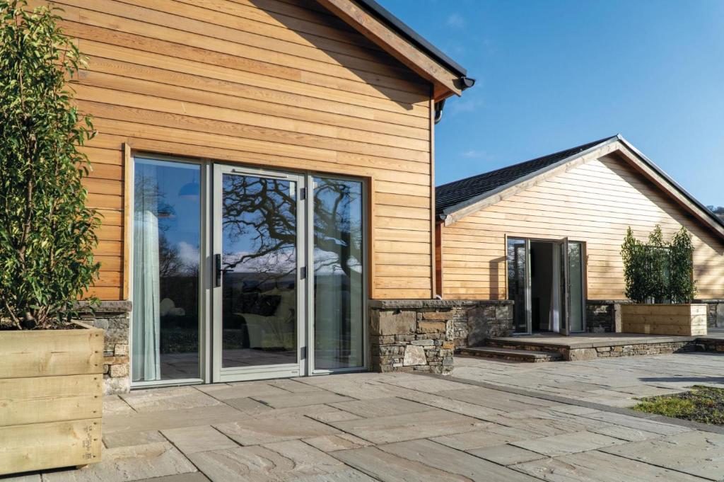 a house with sliding glass doors on the side of it at Suite 11 - Sleeping Giant Hotel - Pen Y Cae Inn in Brecon