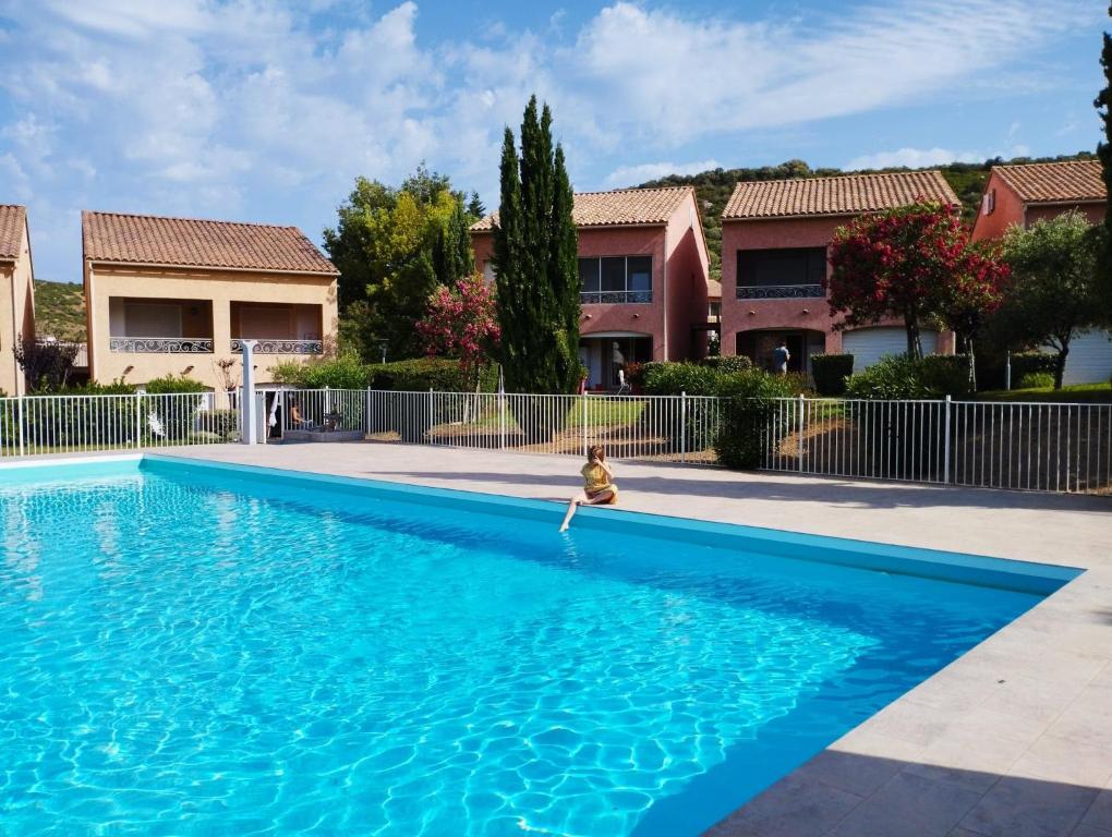 a person is standing in a swimming pool at Casarella Massari in Oletta