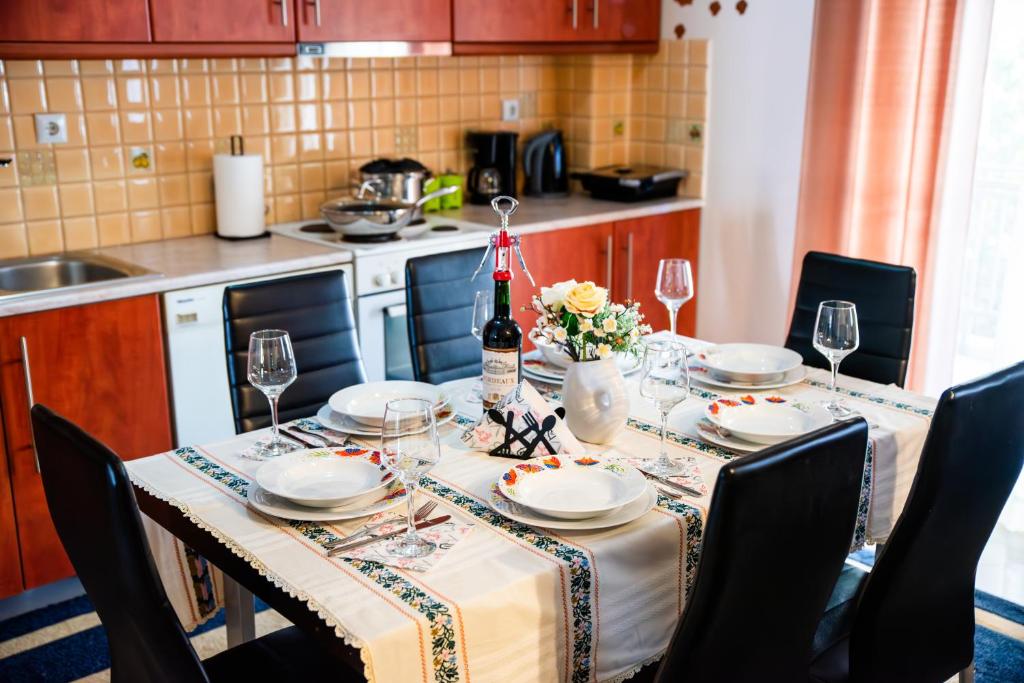 a dining room table with a bottle of wine and glasses at Peaceful House Stylida in Stilís