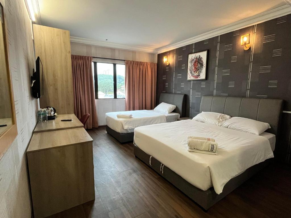 Postel nebo postele na pokoji v ubytování Fair Park Hotel