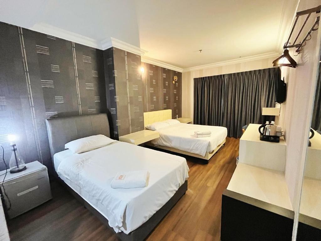 Postel nebo postele na pokoji v ubytování Fair Park Hotel
