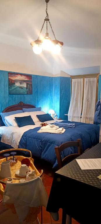 a hotel room with two beds and a table with a tableablish at Le Vie del Castello in Francavilla Bisio