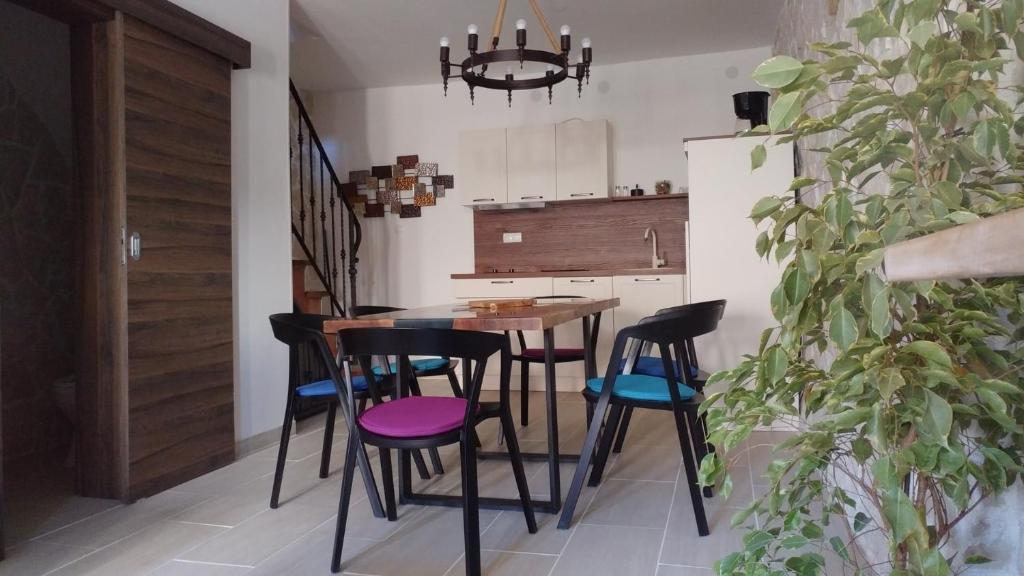 a kitchen with a wooden table and four chairs at Apartment Tia Vis in Vis