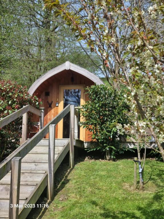 a small wooden cabin with a ramp leading to it at Mountain Edge Resort Mega pod 4 with Hot Tub in Church Stretton