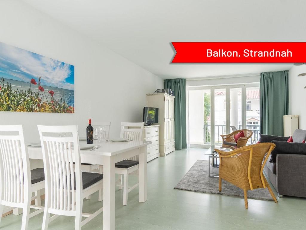 a white dining room with a white table and chairs at Villa Strandidyll Neubau Ferienwohnung 1 2 mit Balkon in Binz