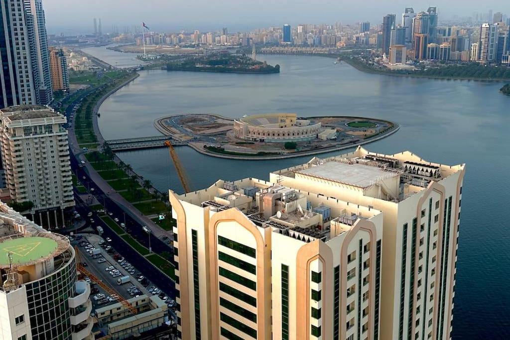 an aerial view of a city with a river and buildings at شقة في الشارقة in Sharjah