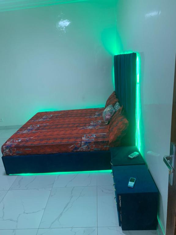 a bed in a room with a blue light at chambre Dakar tres lix in Ngor
