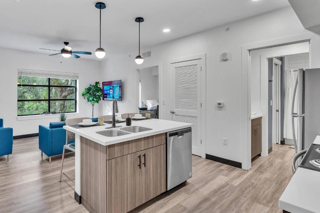 an open kitchen and living room with a sink at The Well 206 in Zephyrhills