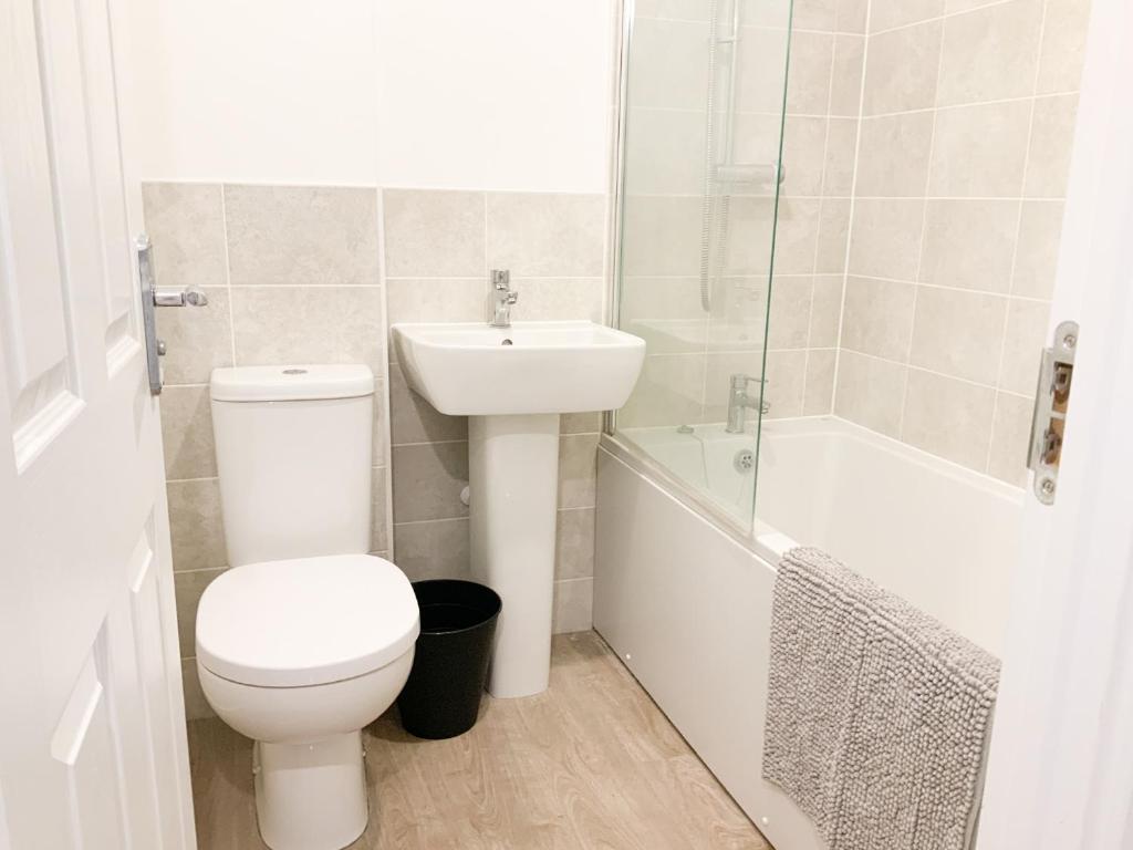 a bathroom with a toilet and a sink and a shower at Jockey house in Andover