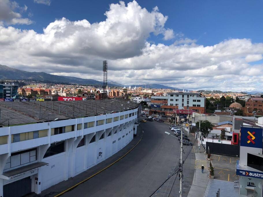 a view of a city with a street and buildings at Mirador del Estadio in Cuenca