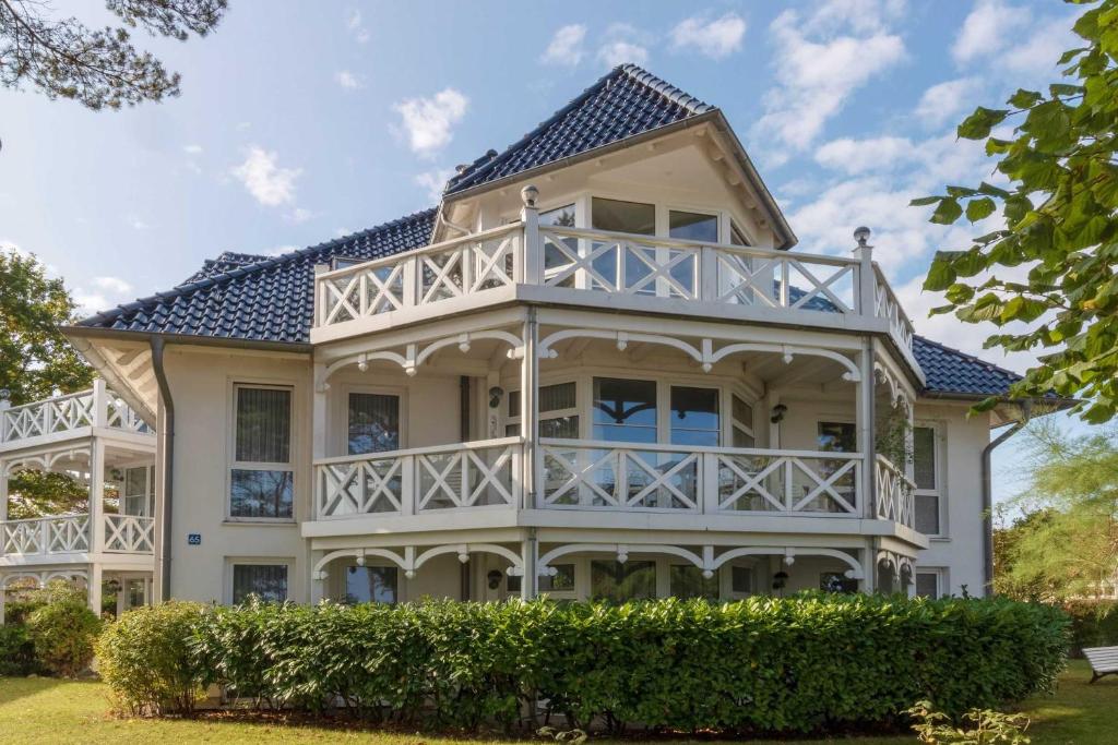 a large white house with a blue roof at Strelasund in Binz