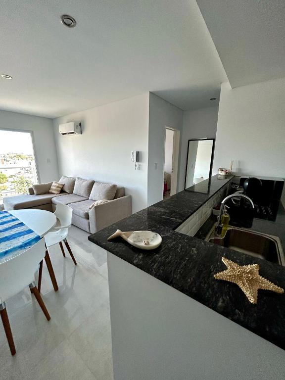 a kitchen and living room with a starfish on a counter at Caleta View Marítimo in Puerto Madryn