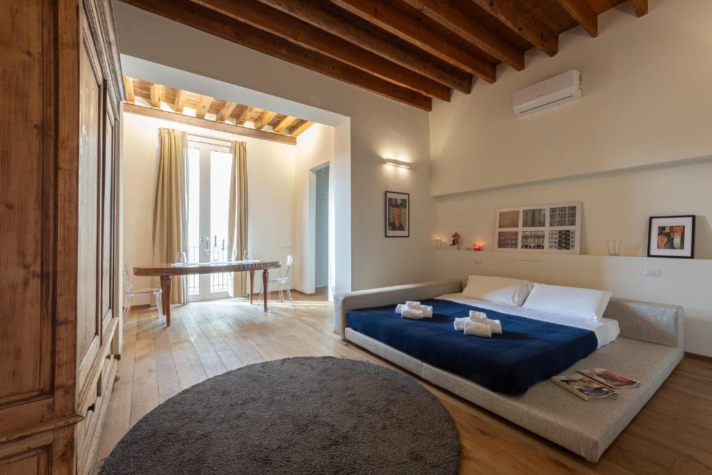 sypialnia z łóżkiem i stołem w pokoju w obiekcie OGNISSANTI Suite-Hosted by Sweetstay we Florencji