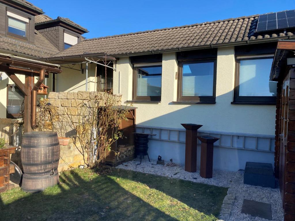 a house with a fence and a yard at Ferienwohnung Fischer in Rödental in Rödental