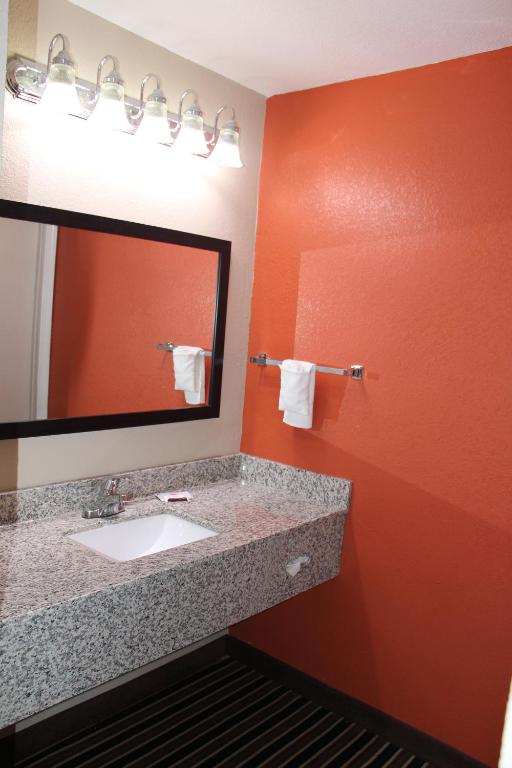 a bathroom with a sink and a mirror at Westbridge Inn & Suites in Clinton