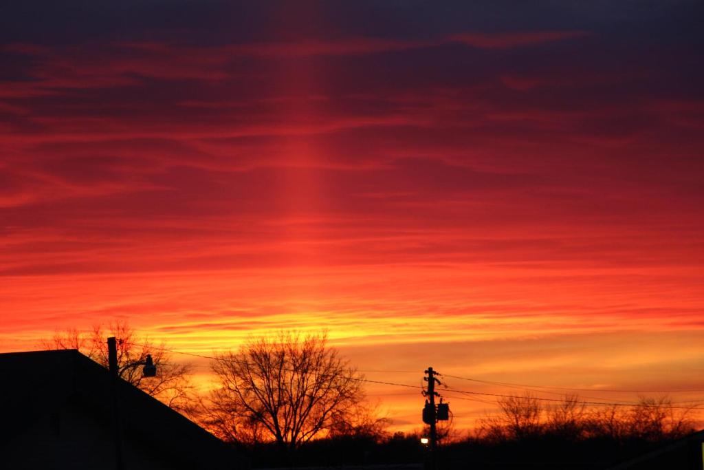 a sunset with a red and orange sky at Westbridge Inn & Suites in Clinton