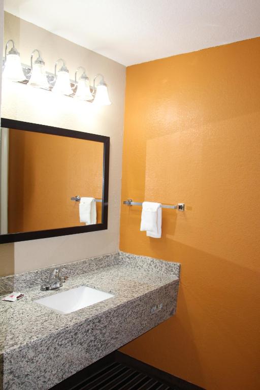 a bathroom with a sink and a mirror at Westbridge Inn & Suites in Clinton