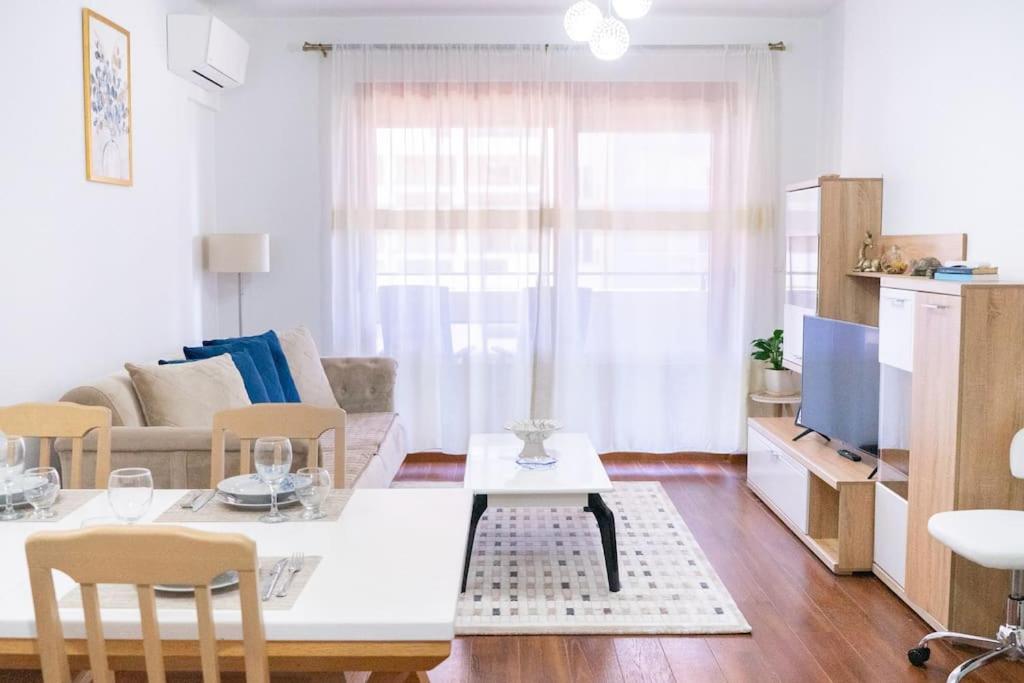 a living room with a table and a couch at Ana Lux Master apartament in Podgorica