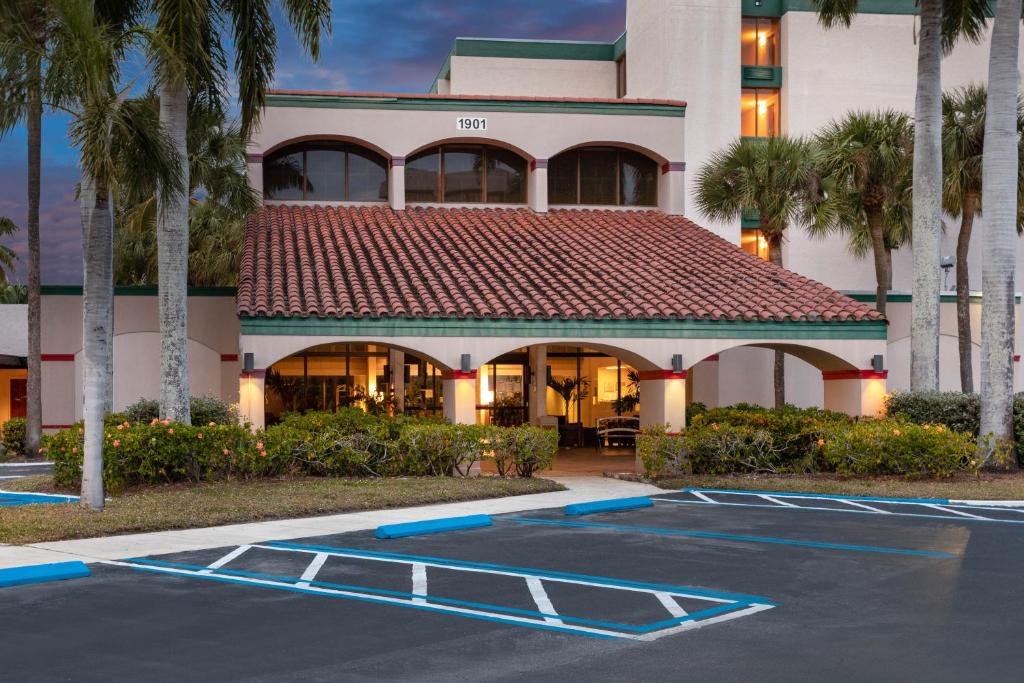 a building with a basketball court in a parking lot at 88 Palms Hotel & Event Center in West Palm Beach