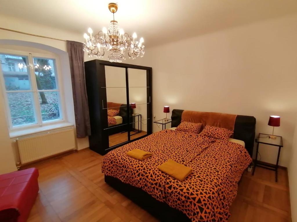 a bedroom with a bed and a large mirror at ZAGREB Botanical Garden Budget Apartment in Zagreb