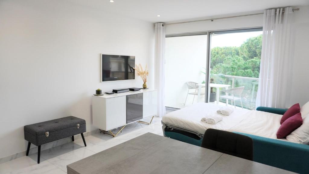 - une chambre avec un lit, une télévision et un balcon dans l'établissement Proche centre ville, Magnifique studio By Palmazur Vacances, à Cannes