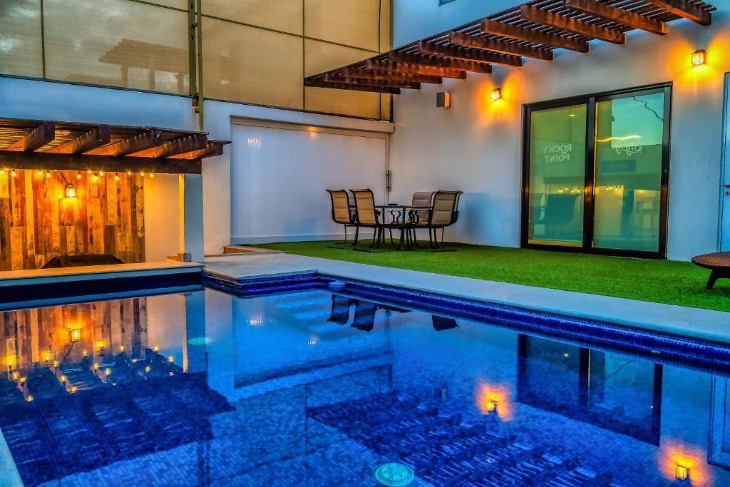 an indoor pool with a table and chairs next to a house at Casa Azul F2 in Puerto Peñasco