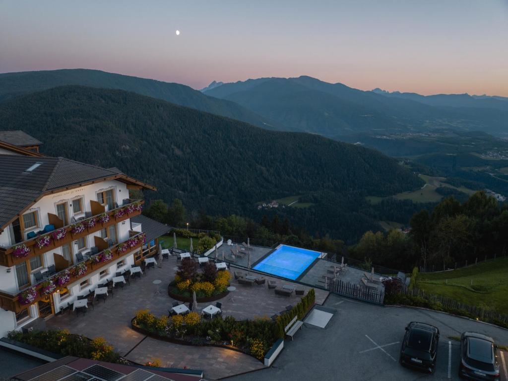 an aerial view of a building with a swimming pool at Panoramahotel Huberhof in Maranza