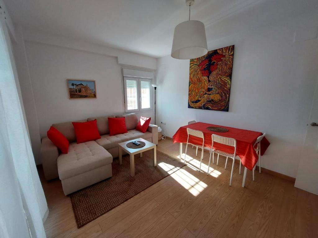 a living room with a couch and a table at Sirena Center apartment in Seville