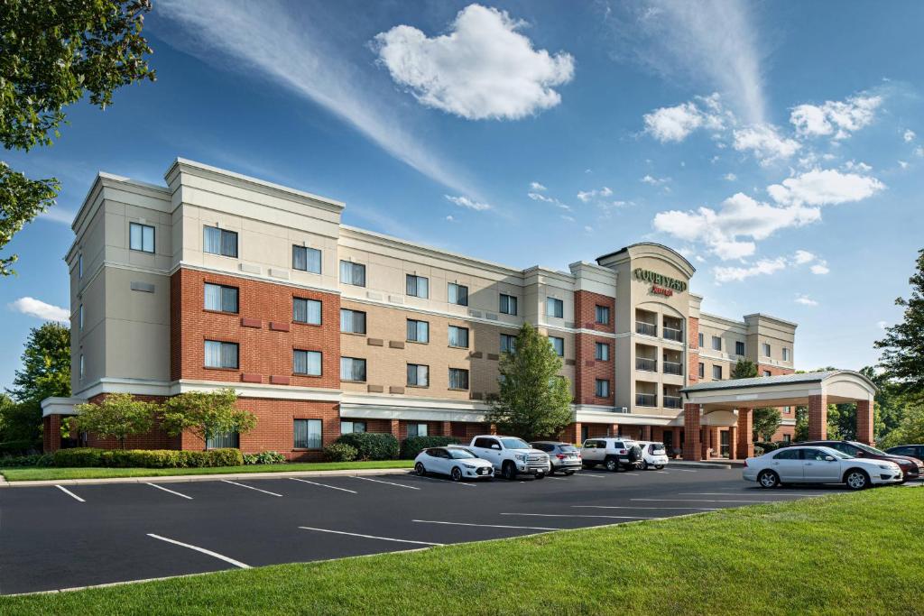 a rendering of a hotel with cars parked in a parking lot at Courtyard Dayton-University of Dayton in Dayton