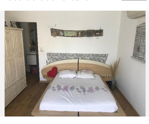 a small bedroom with a bed with flowers on it at A Renasca in Ajaccio