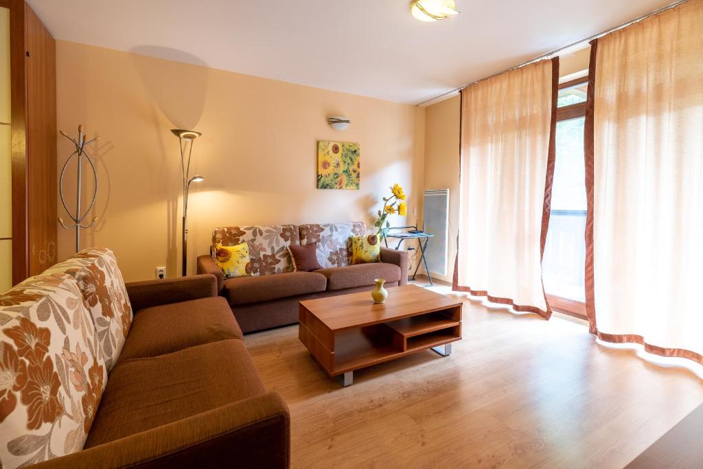 a living room with a couch and a table at Apartmán Slnečnica in Tale