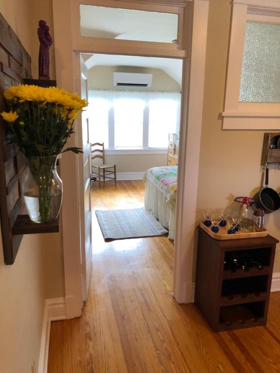 a hallway with a vase with yellow flowers in it at NEW! Apartment in Historic Mansion. Location! Views! in Denver