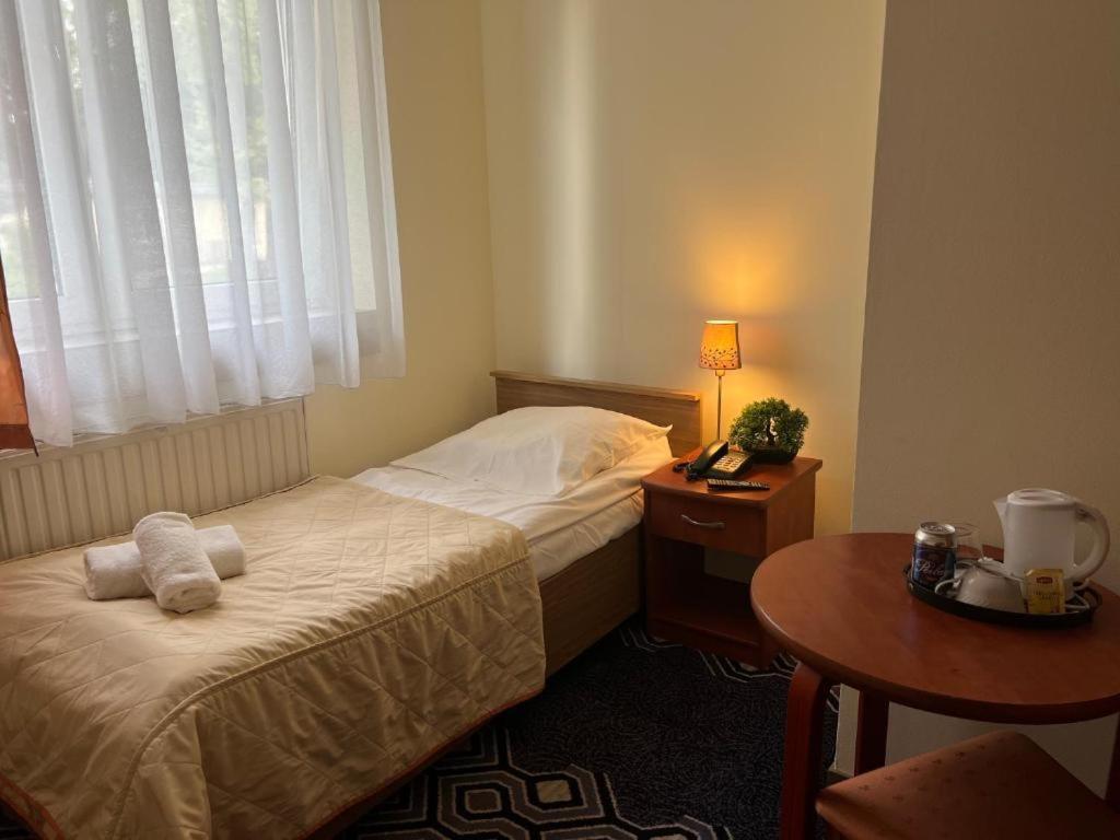 Łóżko lub łóżka w pokoju w obiekcie Hotel Vistula