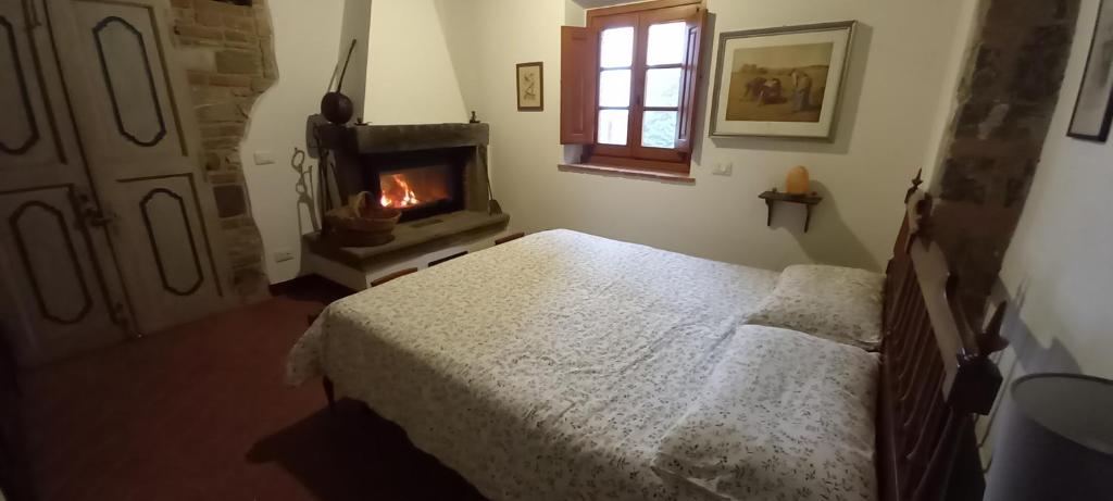 Postel nebo postele na pokoji v ubytování Agriturismo Podere la Cava