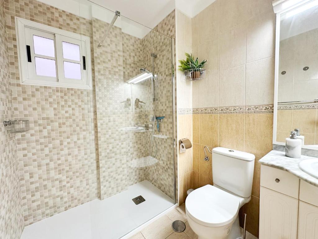 a bathroom with a shower and a toilet and a sink at !!! Relaxing View, The Heights Apartment With Terrace and Heated Pools, Los Cristianos in Los Cristianos