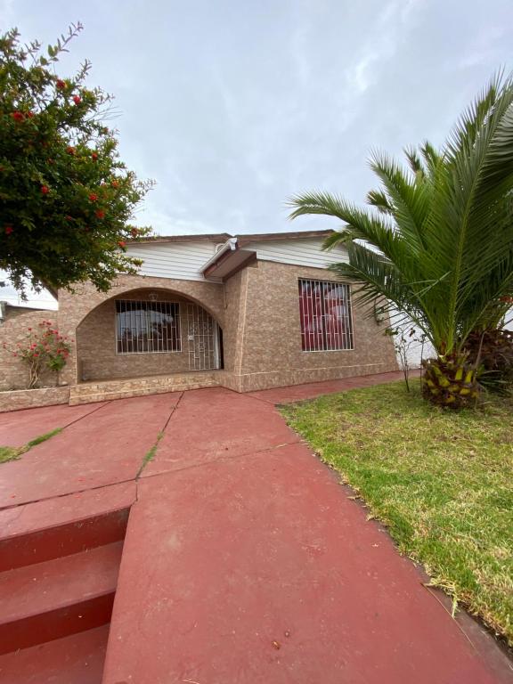 a house with a palm tree in front of it at Casa Quintero in Quintero