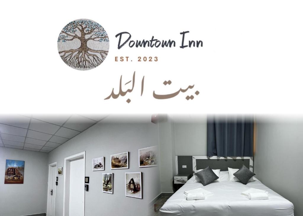 a bedroom with a bed with a tree decal on the wall at Downtown Inn Madaba in Madaba