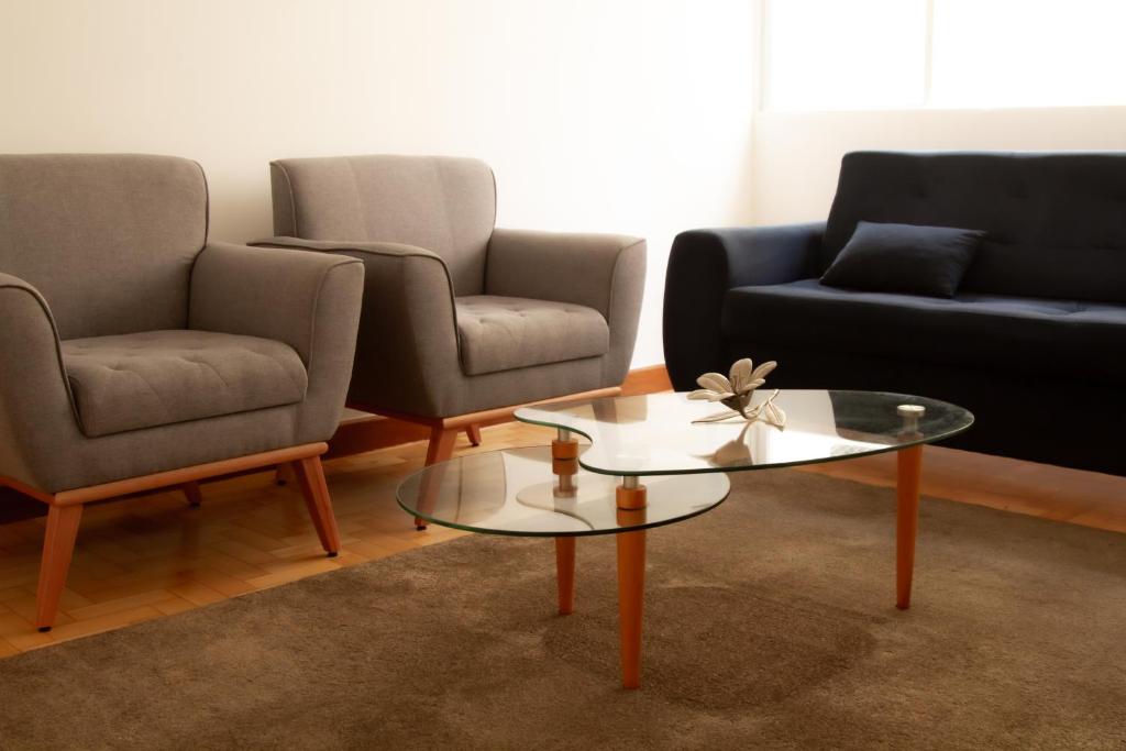 a living room with two couches and a coffee table at Apartamento Gutierrez 02 in Belo Horizonte