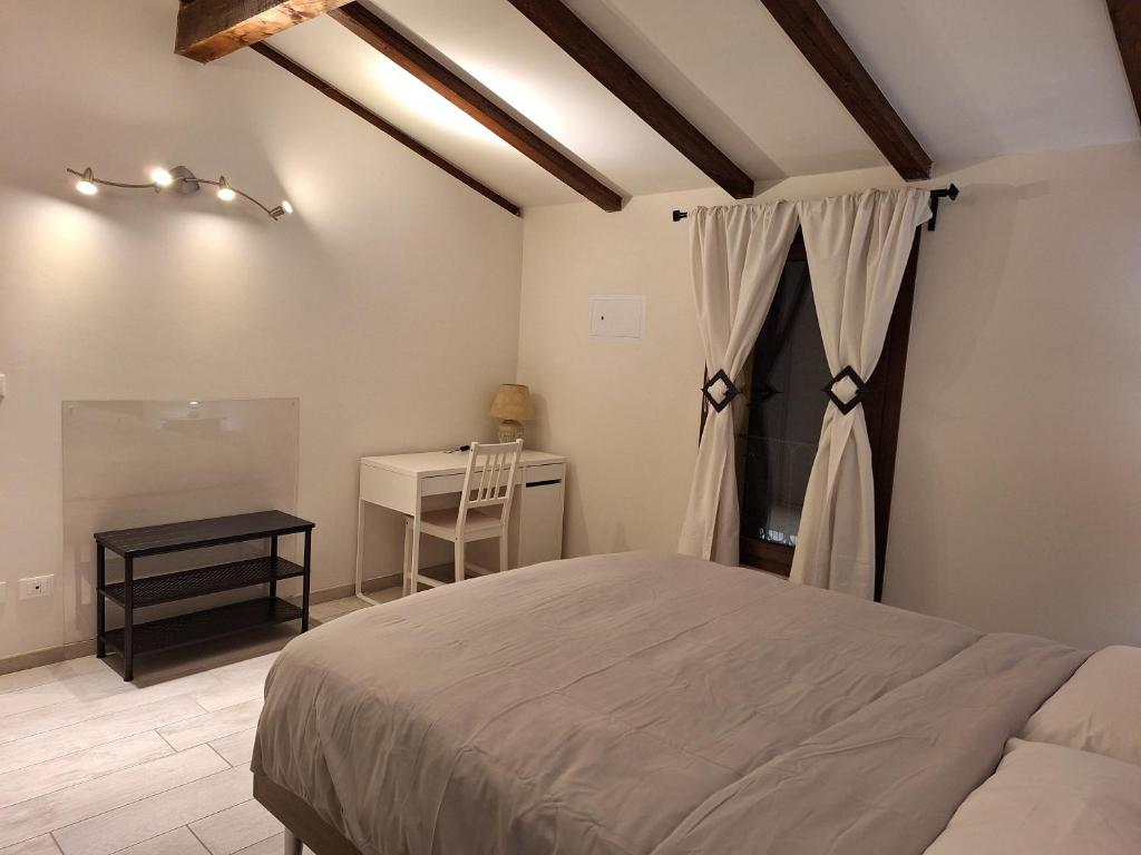 1 dormitorio con cama y escritorio en Appartamento MANARA, en Zola Predosa
