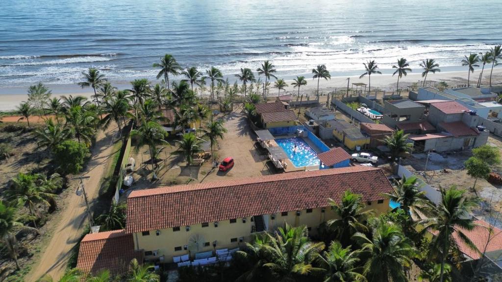 an aerial view of a resort with a swimming pool and the beach at Pousada Costa do Sol in Canavieiras