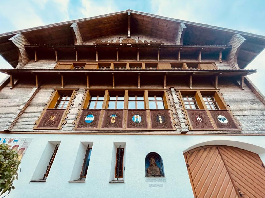 a tall building with windows on top of it at The 1415 See I Erlebnis I Luzern in Beckenried