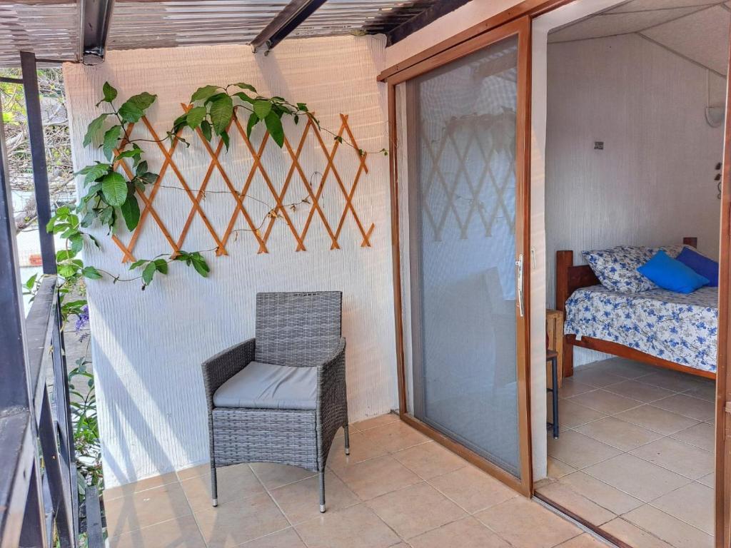 Cette chambre dispose d'une terrasse avec une chaise et un lit. dans l'établissement Villas El Amatle, 