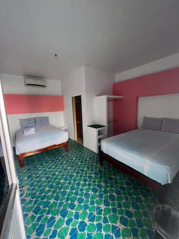 Postel nebo postele na pokoji v ubytování Hotel Casa Cactus HCC