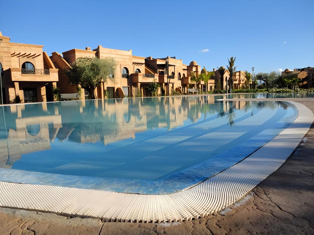 a swimming pool in the middle of a city at Atlas Views By Golf Resort in Marrakesh