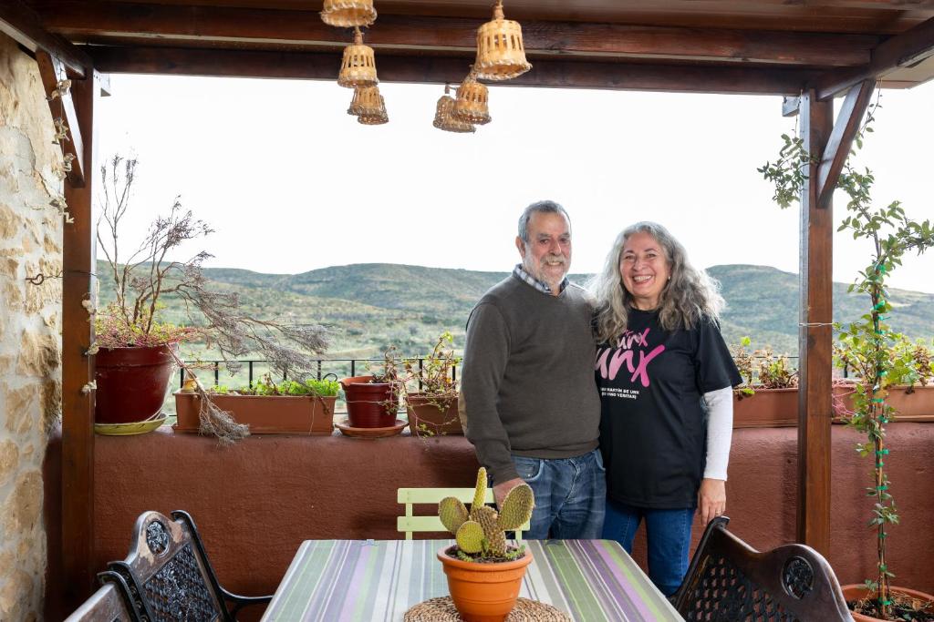 a man and a woman standing on a porch at La Posadica Casa Aldabe in San Martín de Unx