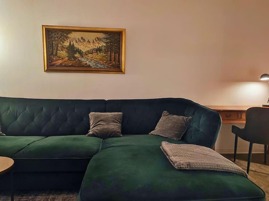 zieloną kanapę w salonie z obrazem w obiekcie Elegantes 3-Schlafzimmer-Nest w mieście Hagen
